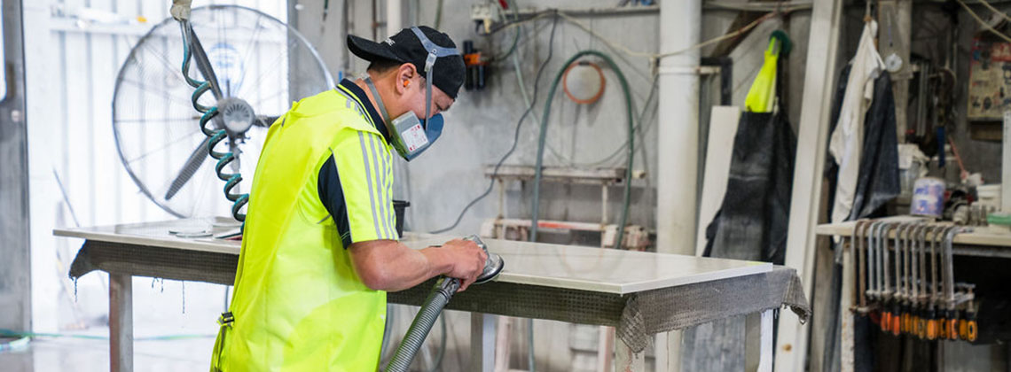 Worker working with engineered stone. 